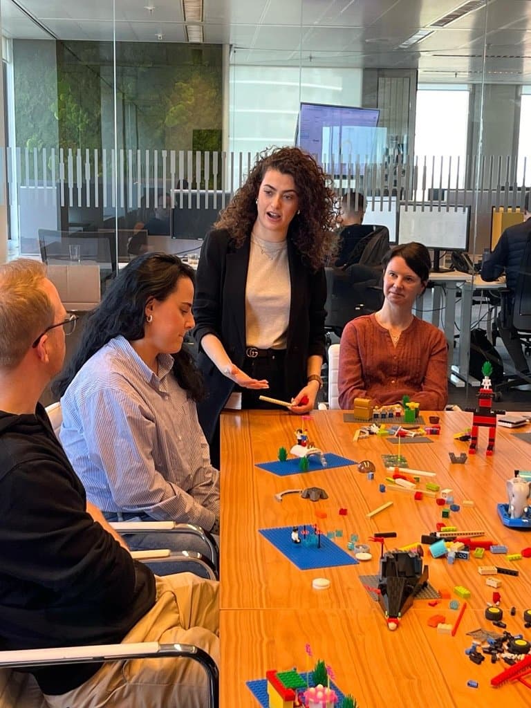Noam facilitating a LEGO® Serious Play® session, completed models on the table